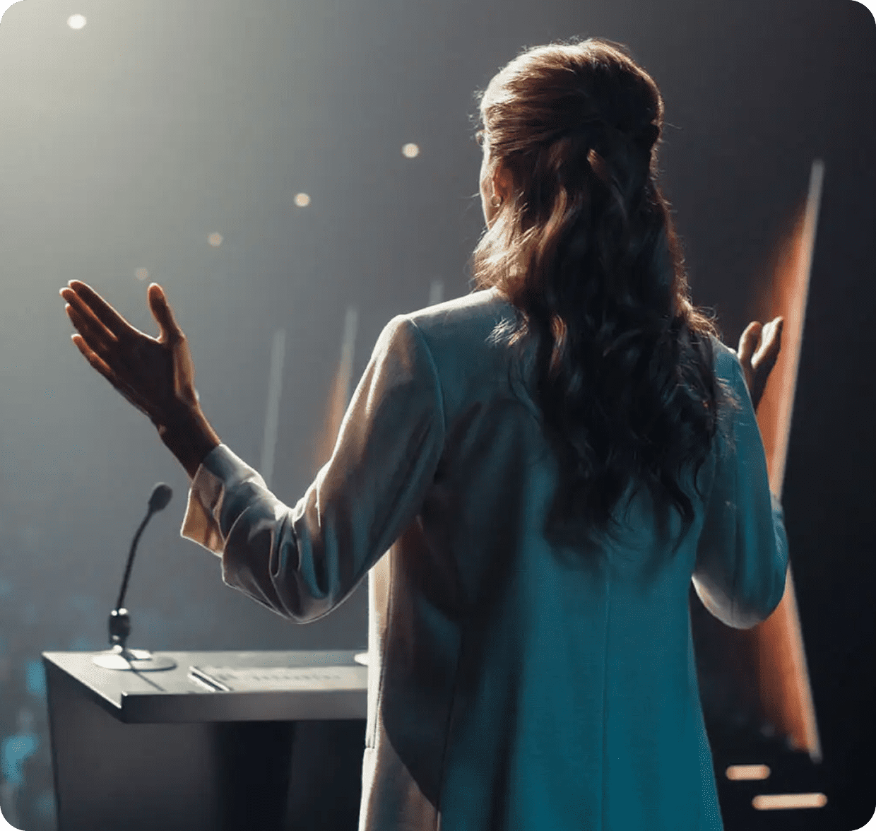Speaker presenting at a conference podium.